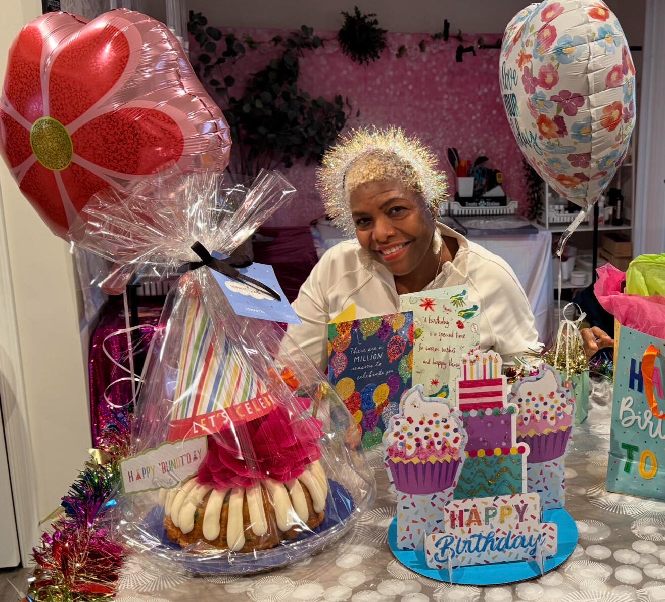 Birthday Blessings Celebration | Tigaro House Woman celebrating her birthday with cards, balloons, and a special birthday surprise from Tigaro House.