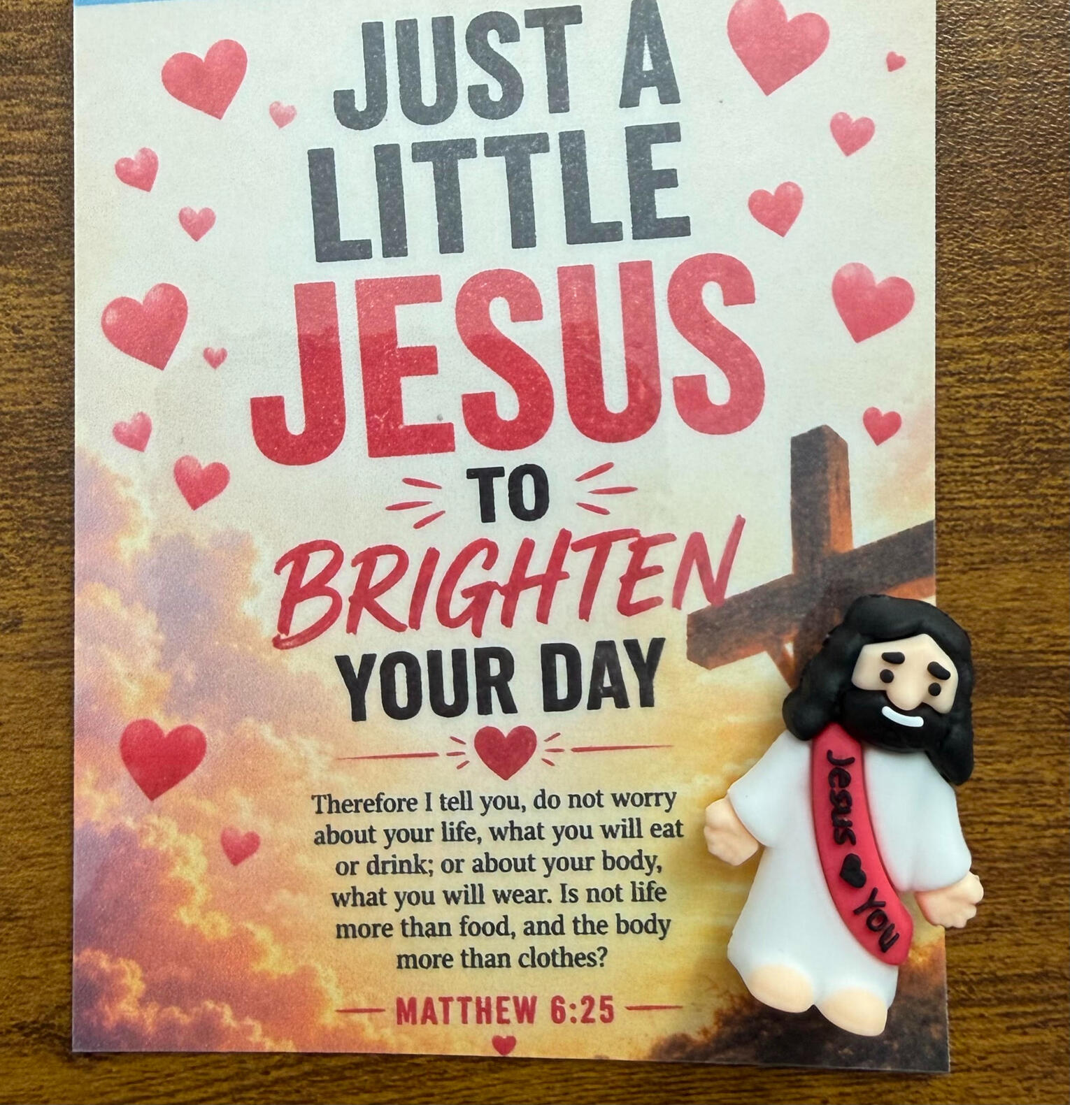 Colorful Christian encouragement sign reading “Just a Little Jesus to Brighten Your Day” with a Bible verse from Matthew 6:25.